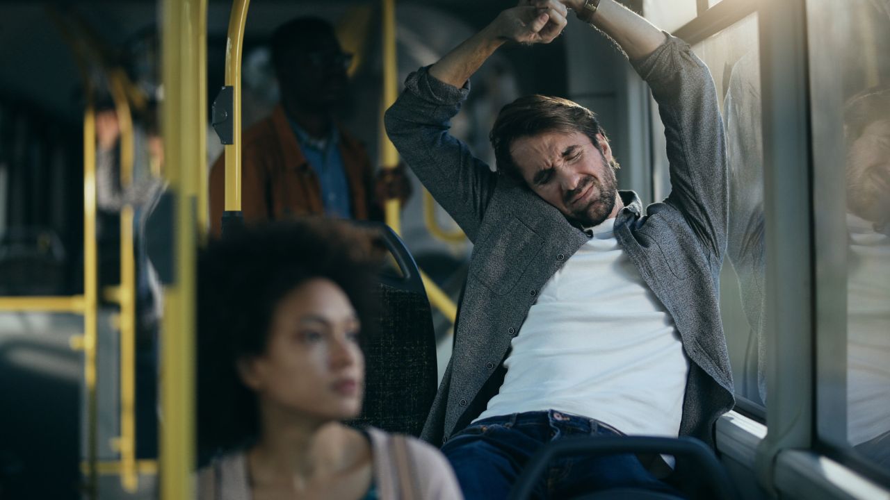 Passenger stretching after a long bus ride