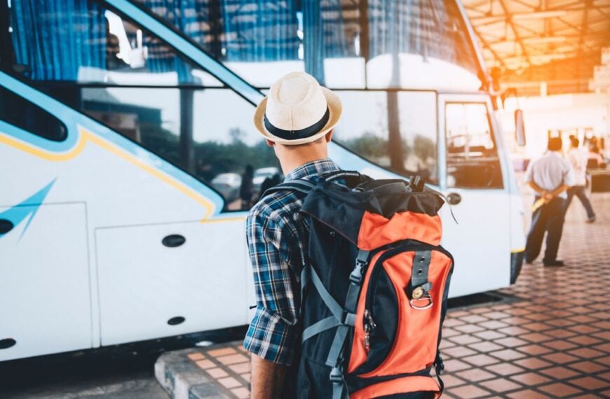 backpack young man traveler wait at the bus station. Travel concept.