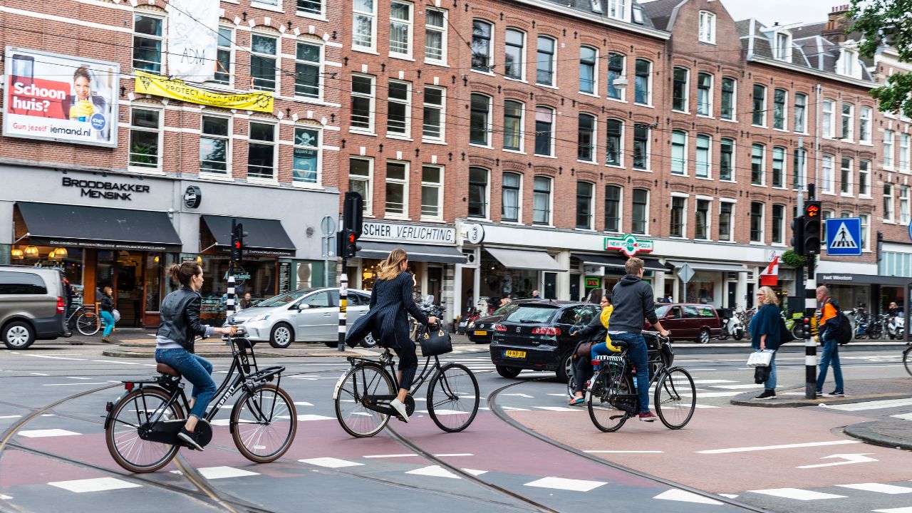 Amsterdam, Netherlands - September 8, 2018: Street with people on bicycle in the old town of Amsterdam, Netherlands