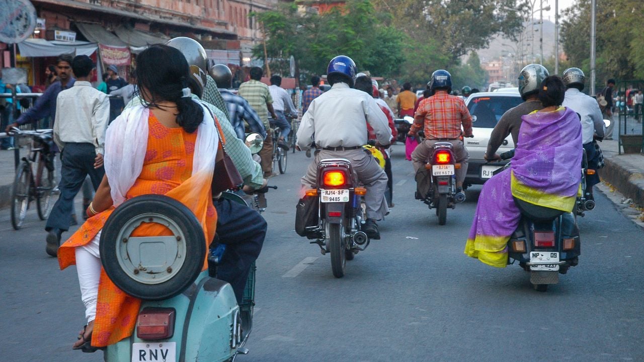Rajasthan, India - February 25, 2006:View of the intense traffic of motorcycles through the streets of the commercial center of Jaipur at nightfall