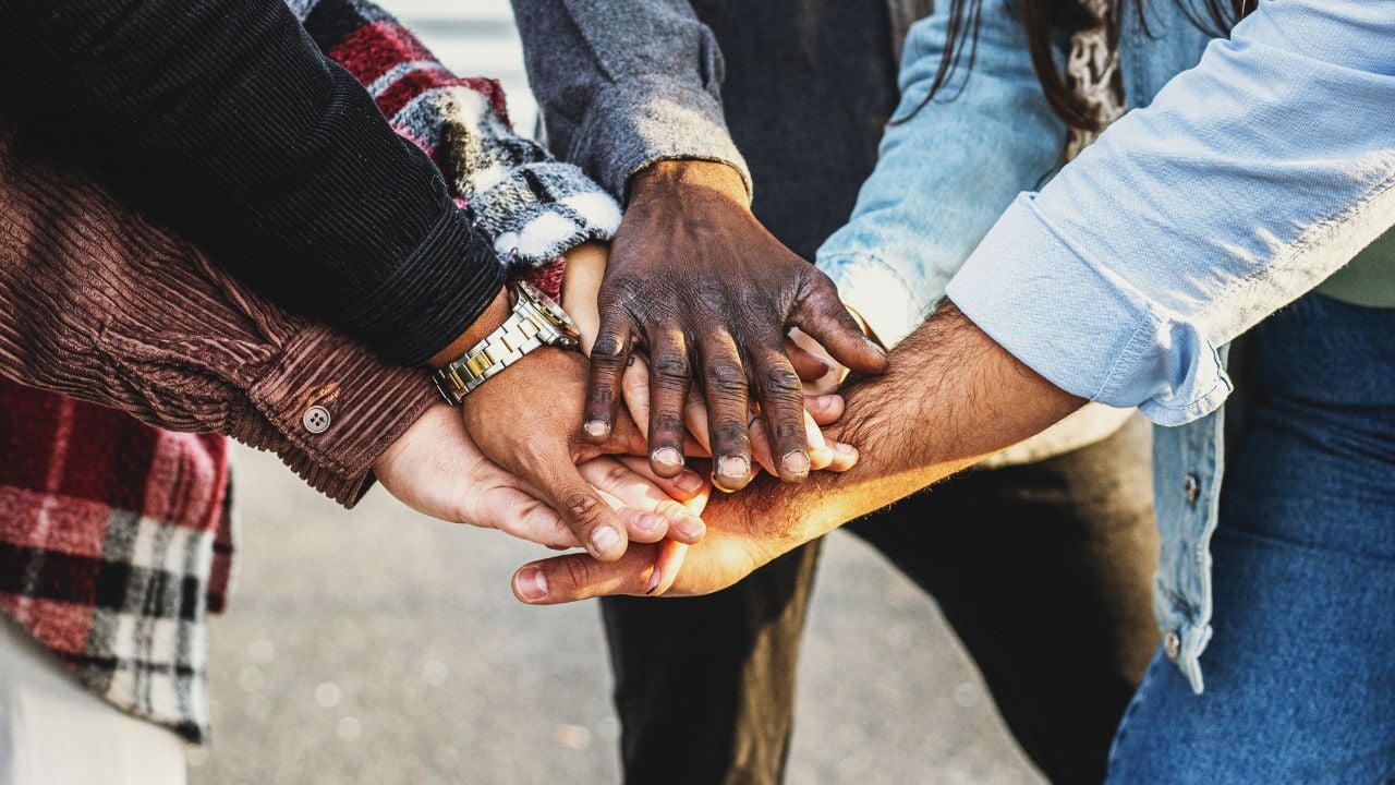 People joining hands in a group