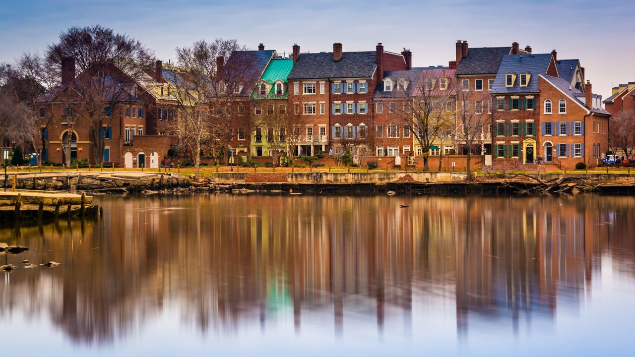 Reflections of waterfront buildings along the Potomac River in Alexandria, Virginia.