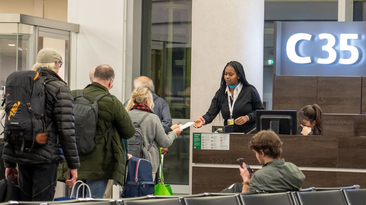 Vienna, Austria - January 18, 2025: Passengers at the gate to the plane at Vienna Airport. Tourists are waiting in line to board the plane. Boarding gate, checking boarding documents.