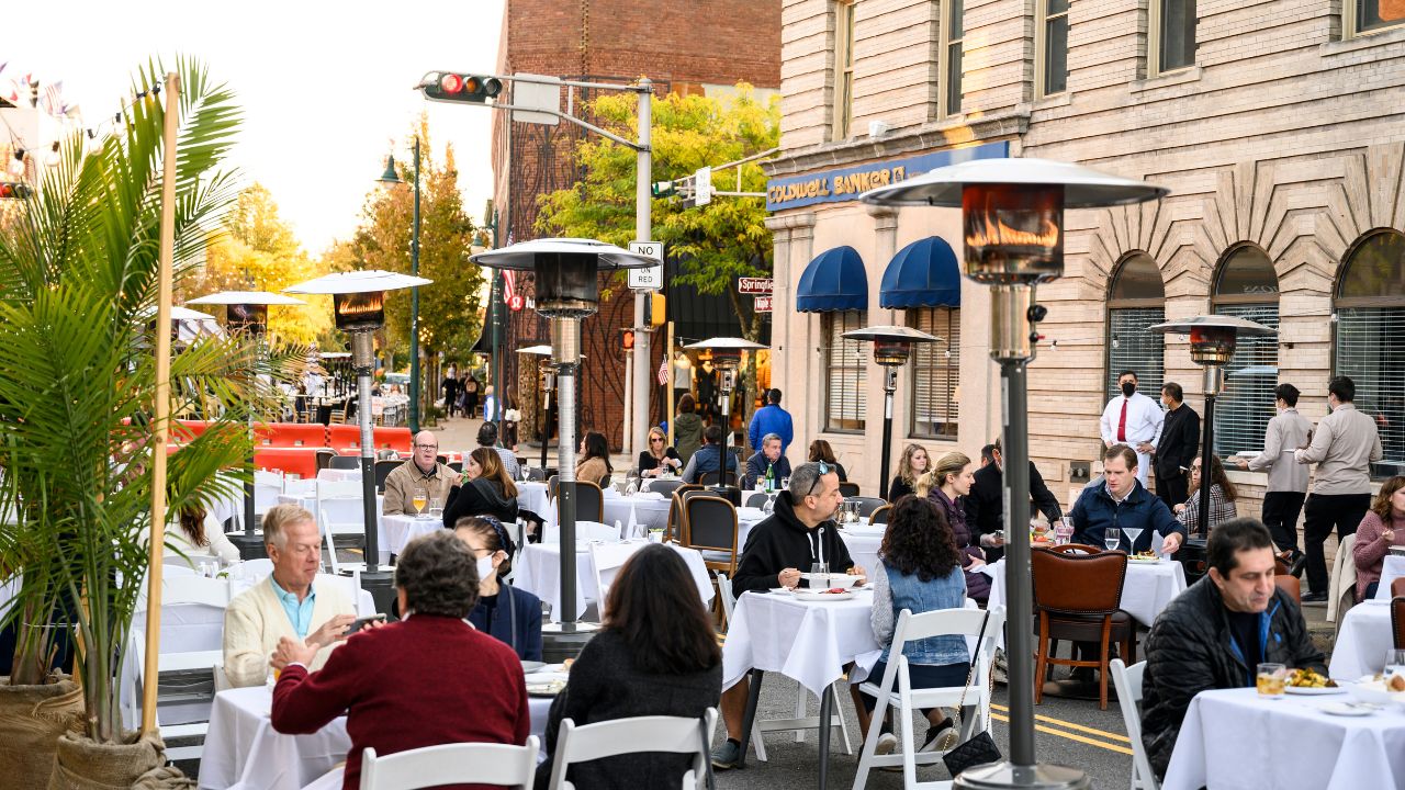 New Jersey USA - October 17, 2020: During the coronavirus pandemic restaurant patrons enjoy outdoor dining in New Jersey. There are outdoor heat lamps.