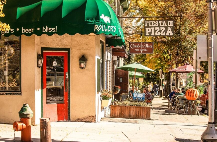 A charming street scene features outdoor seating and colorful storefronts, including a pizza place and restaurant. Chestnut Hill, Philadelphia, Pennsylvania, USA November 3, 2024
