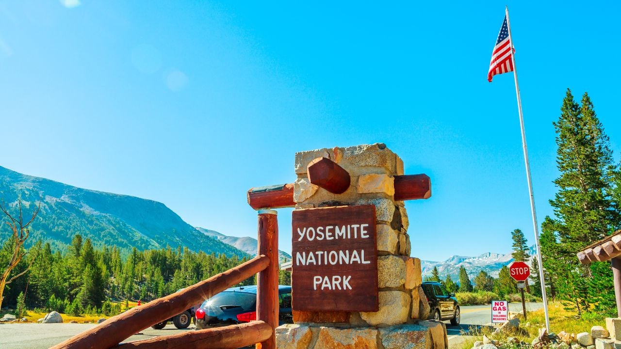 Entrance gate with American flag of Yosemite National Park. Summer American holidays in California of United States of America.