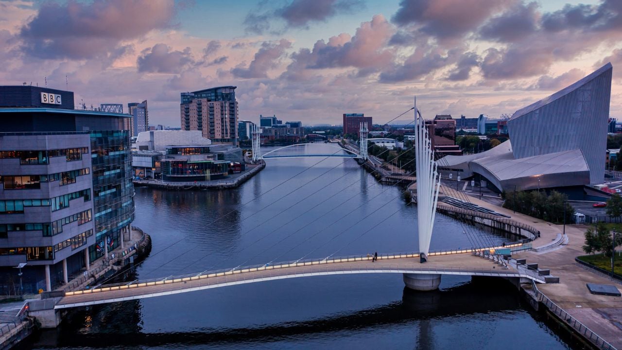 Manchester, UK. August 10, 2021. Aerial view of the Media City UK is on the banks of the Manchester Ship Canal in Salford and Trafford, Greater Manchester, England at dusk.