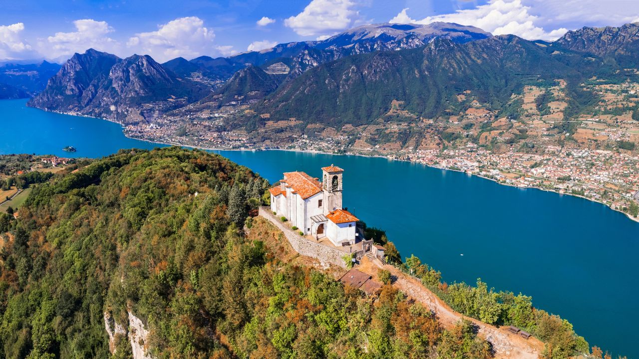 Italian lakes scenery. Amazing Iseo lake aerial view. one of the most beautiful places - Shrine of Madonna della Ceriola in Monte Isola - scenic island in the moddle of lake. Italy travel destination