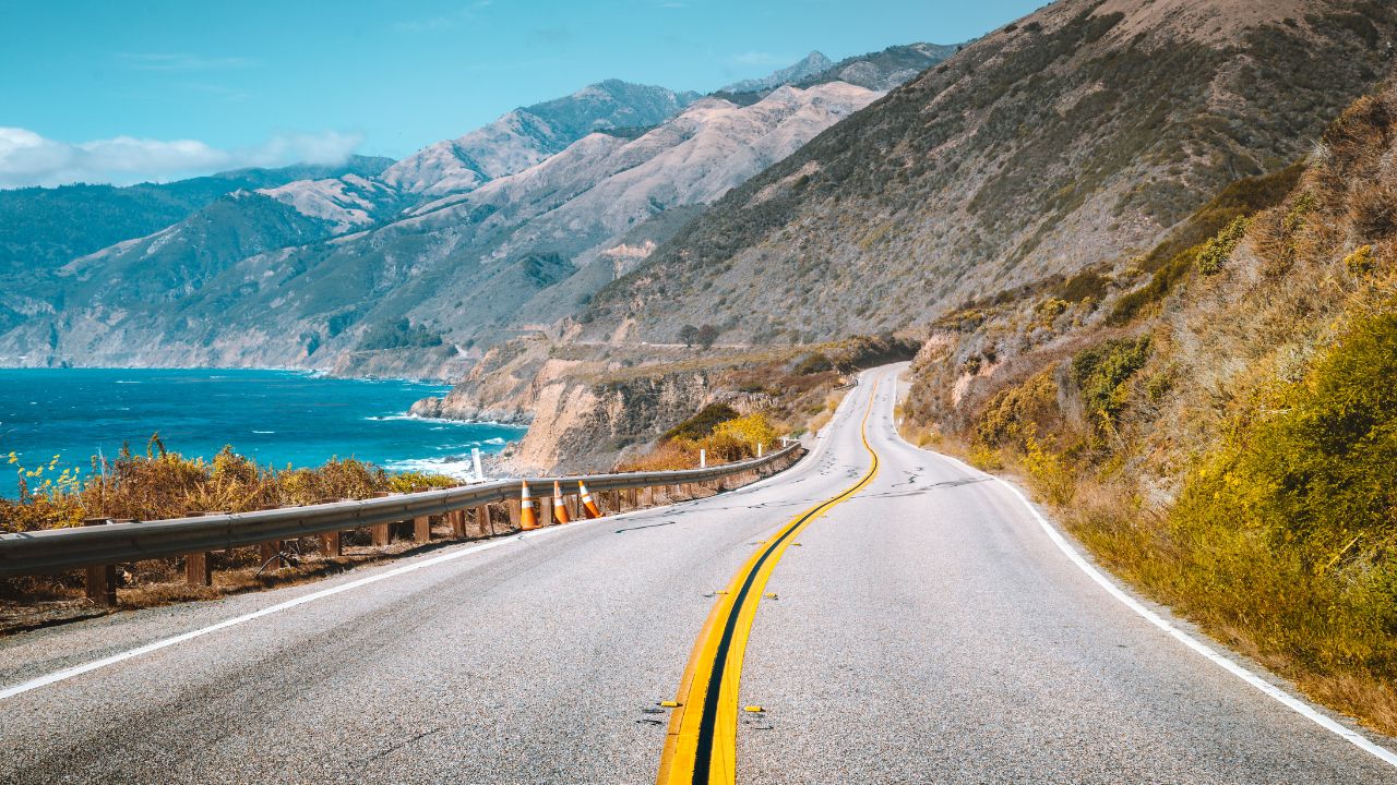 Scenic view of world famous Highway 1 with the rugged coastline of Big Sur in beautiful golden evening light at sunset in summer, California Central Coast, USA
