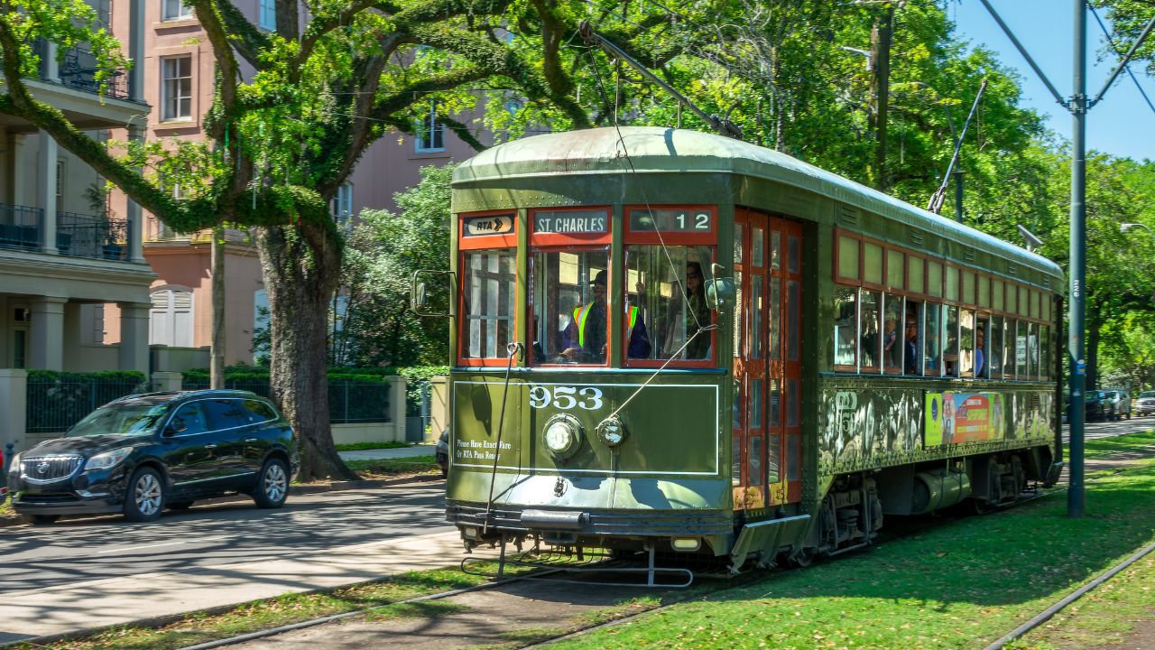 NEW ORLEANS, LOUISIANA - APRIL 8: Green streetcar and trees, St Charles line in the Garden district, on April 8, 2025 in New Orleans, Lousiana