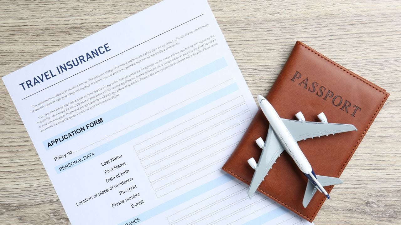 Medical tourism. Travel insurance application form, passport and airplane model on light wooden background, top view