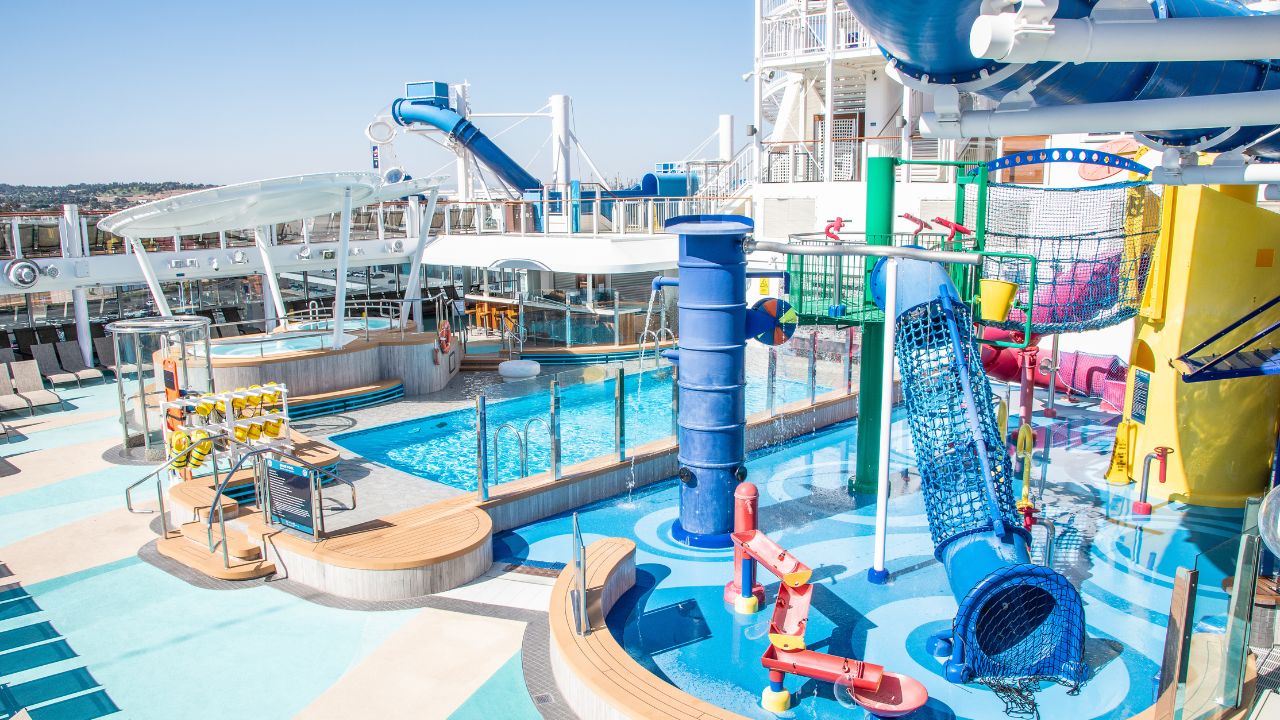 San Pedro, California - October 11 2019: Empty sun deck onboard Norwegian (NCL) Joy Cruise Ship with waterslides and pools for adults and children, hot tubs, and lounge chairs for sunbathing.