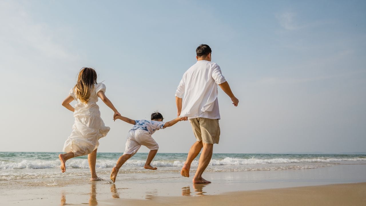 Family holiday vacation beach. Asian happy family outdoors summer travel. Fun families outdoors. Family vacation beach. Life assurance plan. Families financial planning Joyful relaxing Playing outside