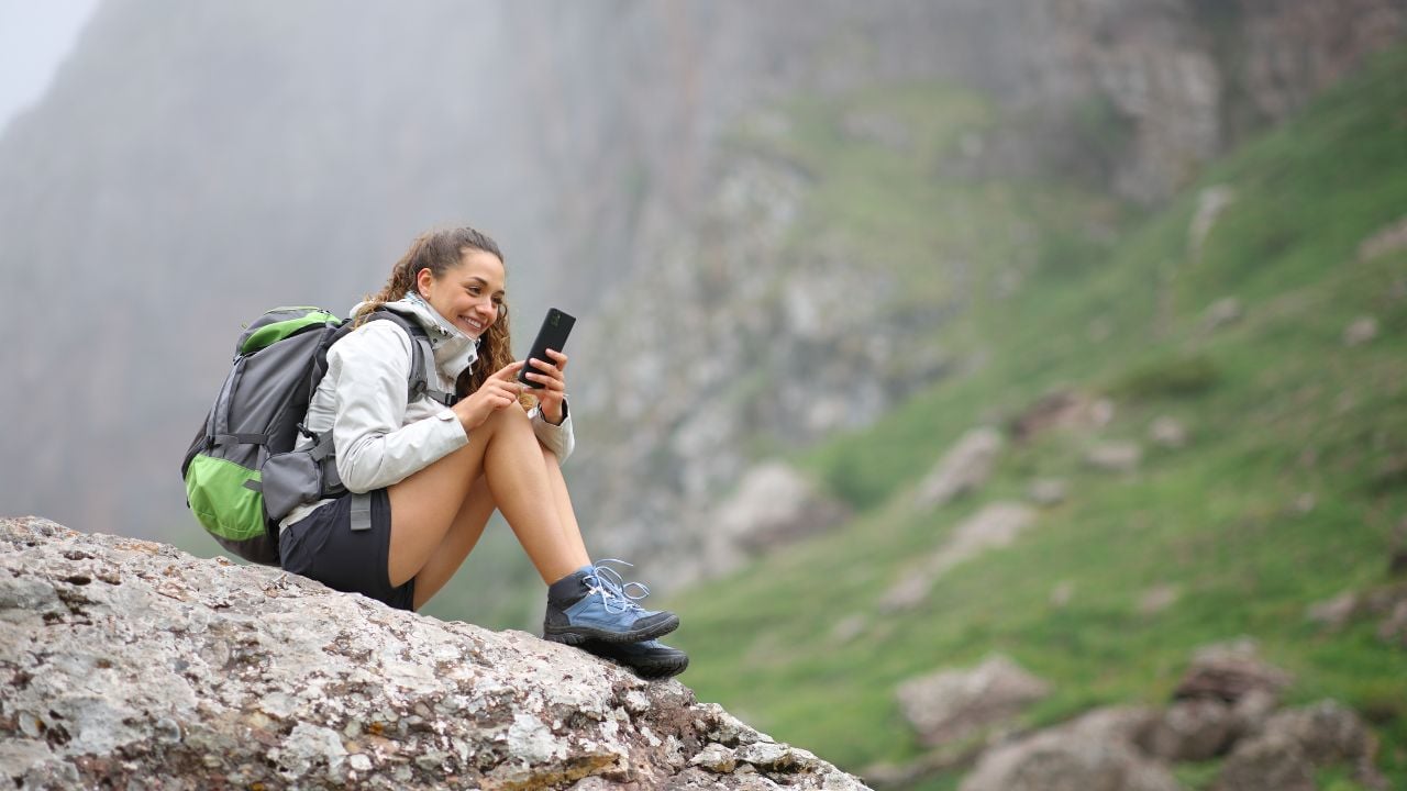 Hiker using a smartphone in nature