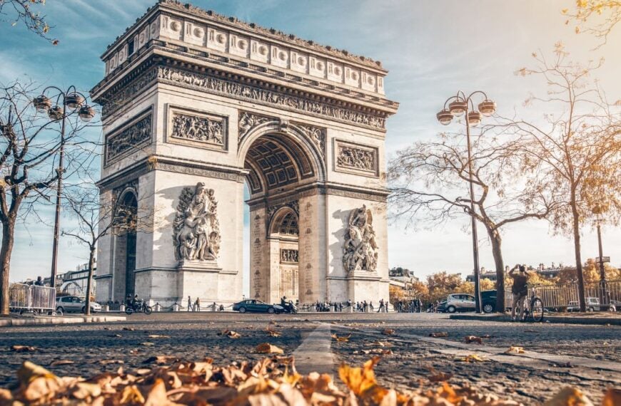 Arc de Triomphe located in Paris, in autumn scenery.