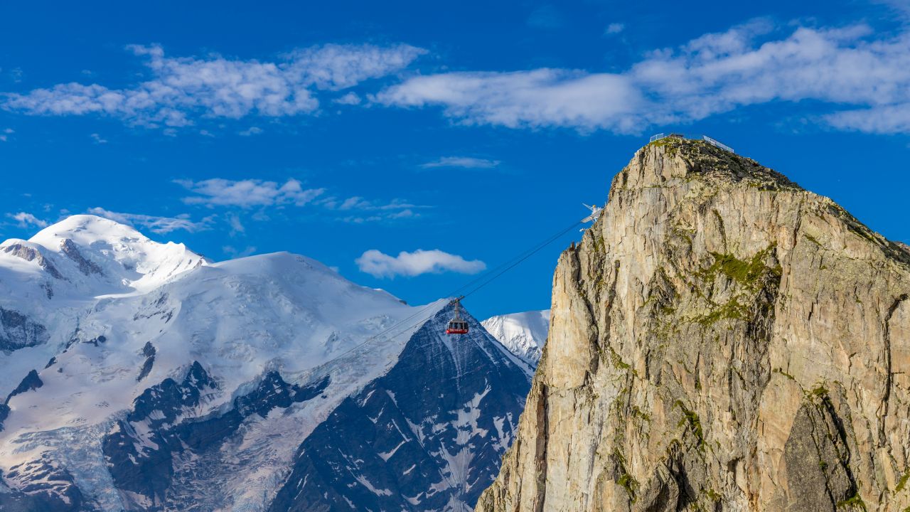 Brevent mountain summit in Chamonix valley. Rocky mountain top with cable car famous for climbing, hiking and paragliding from its slopes. Brevent summit in the Alps on a sunny day