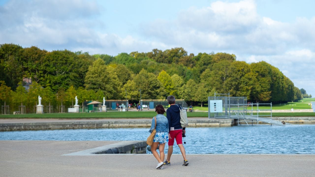 Paris, France –Aug 27,2023: two Asian Tourists walk in the Versailles Palace, travel, holiday