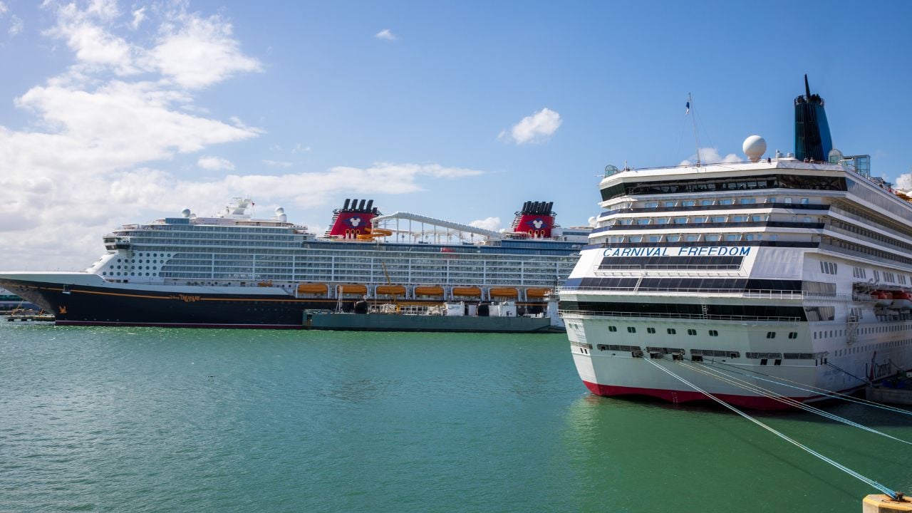 Port Canaveral, Florida, USA - October 25, 2025. Large cruise ship at dock in Port Canaveral. Large ship in dock with blue calm water. Blue sky and puffy clouds.