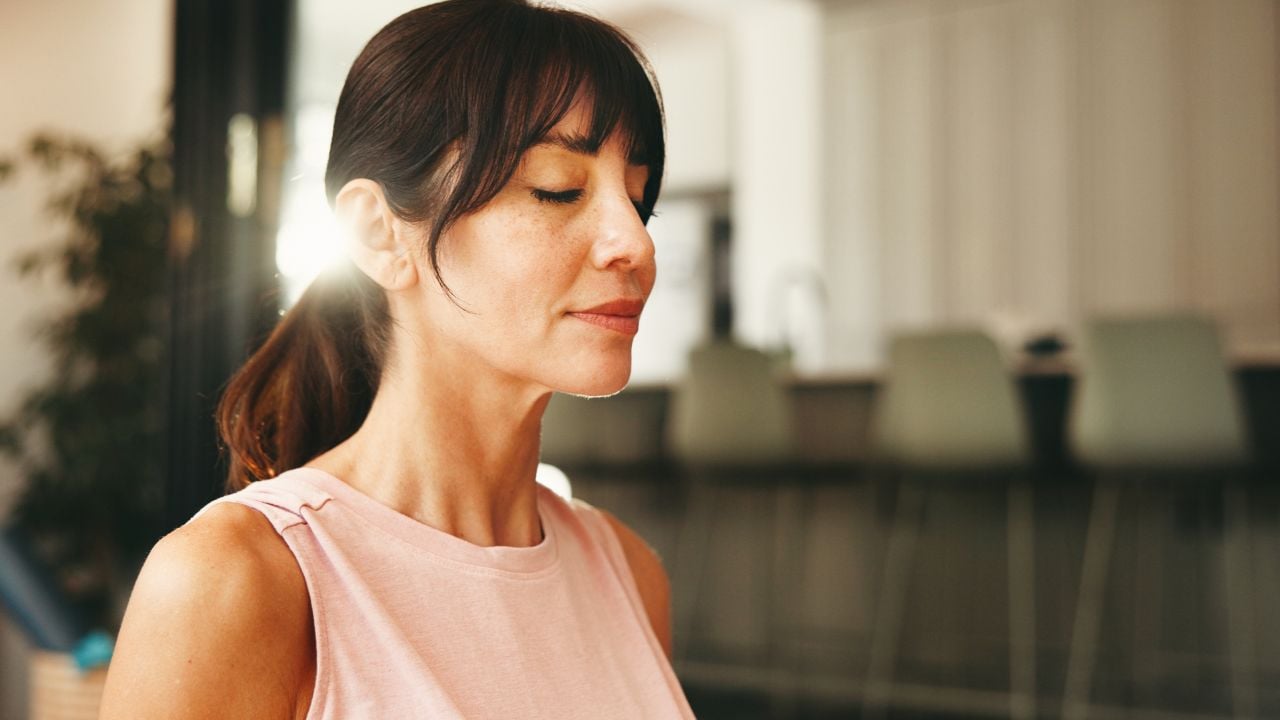 Woman, breath and meditation for yoga in home with zen, spiritual awareness and holistic healing. Mature person, inhale exercise and mindfulness with inner peace, balance and mental health wellness