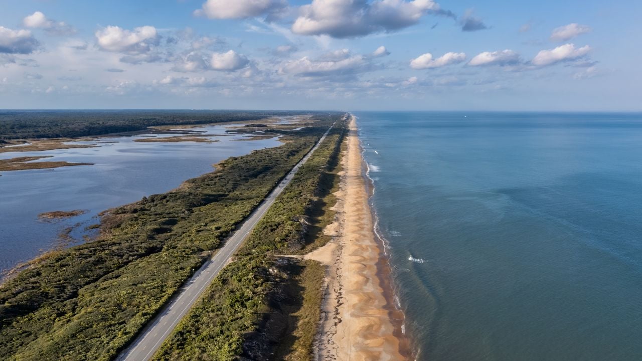 North facing aerial drone view of Northeast Florida beach coastline, the A1A and the Guana River over the Guana Tolomato Matanzas National Estuarine Research Reserve GTM Research Reserve