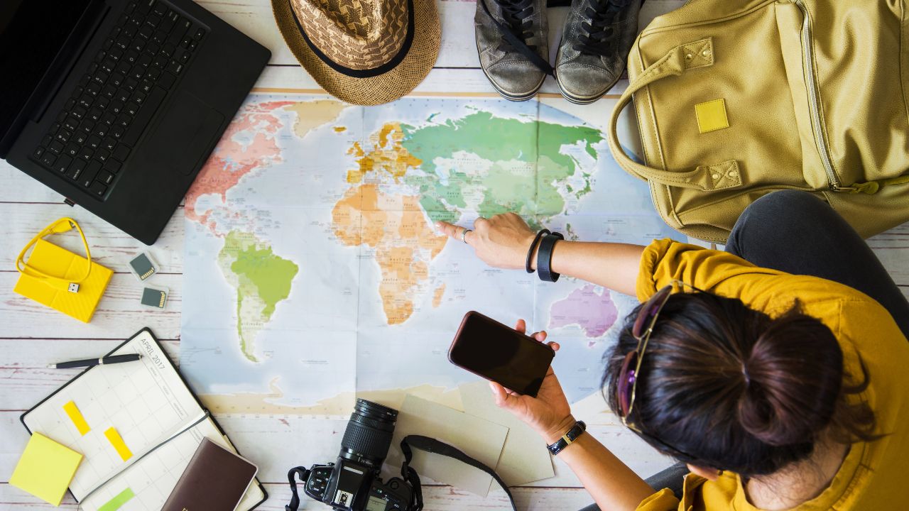 Vacation travel planning concept with map. Overhead view of equipment for travelers.
