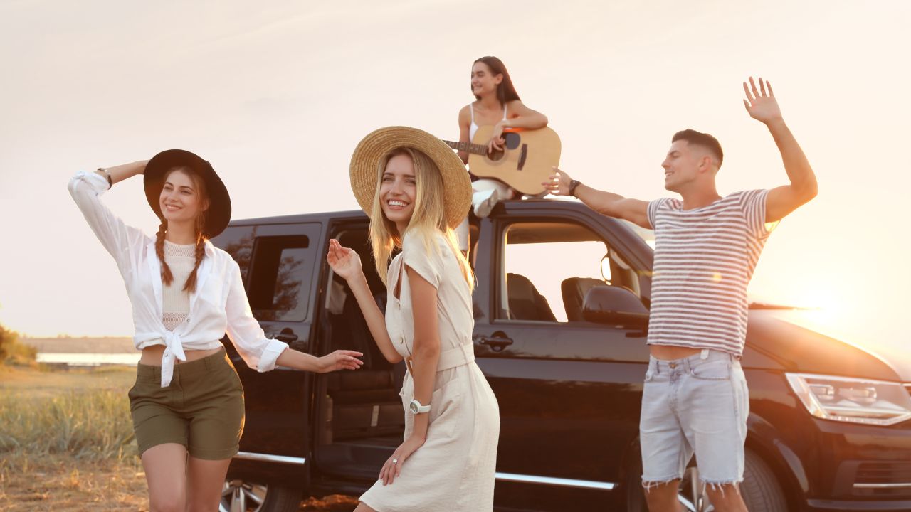 Friends enjoying a road trip at sunset