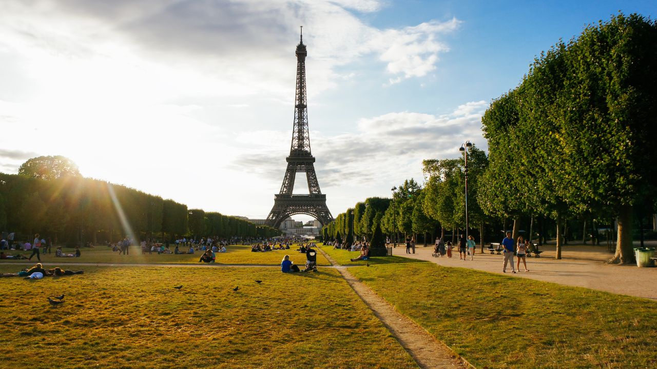 Eiffel tower summer park scene with sunshine beams, Paris. France. Paris park landscape. Famous Eiffel tower with sun beams in Paris, France. Eiffel tower at sunny day Paris, travel landmark concept
