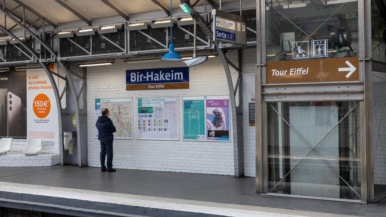 Paris, France - February 28 2023: Man looks at the map of the Paris metro network at the Bir-Hakeim metro station near the Eiffel Tower