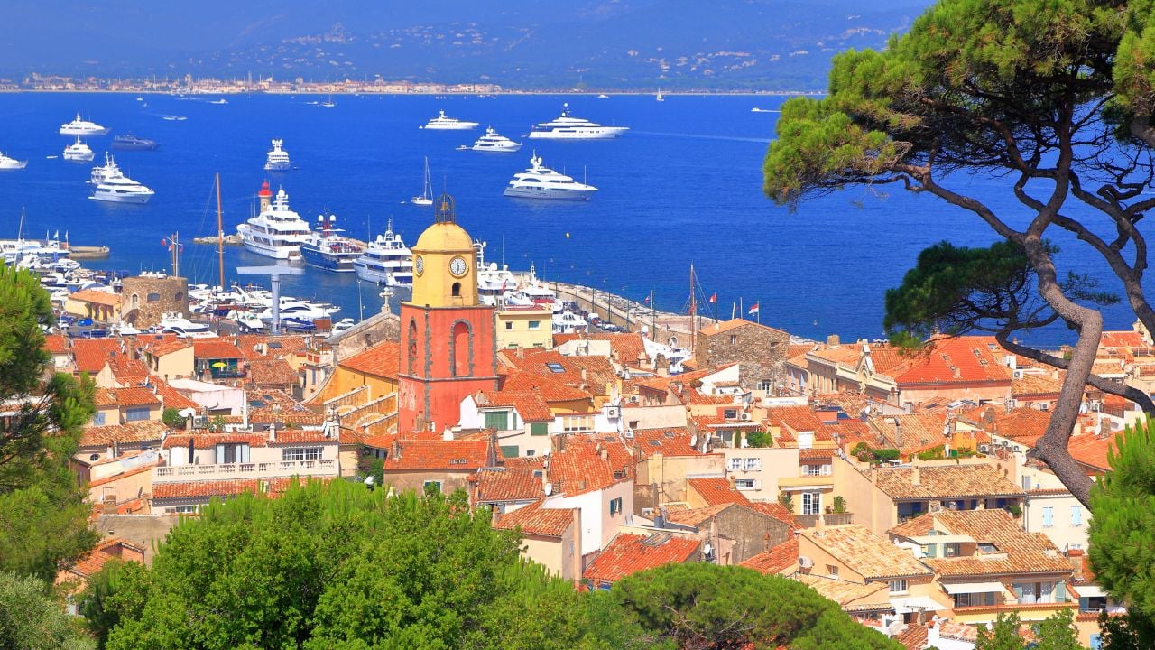 Aerial view to the old town and distant boats, Saint Tropez, French Riviera, France