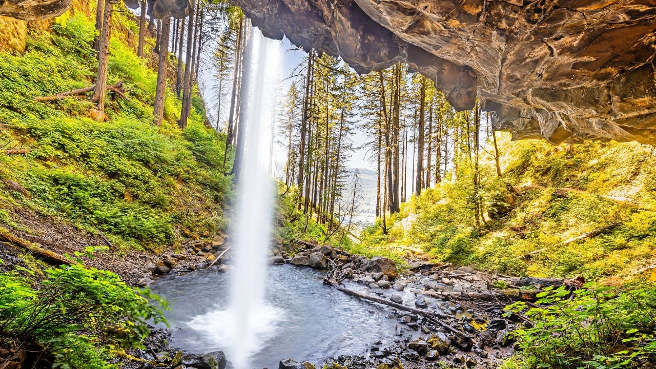 Behind Ponytail Falls, Oregon. The Columbia River Gorge has the greatest concentration of high waterfalls in North America. Starting at Horsetail Falls Trailhead, it's a 10-minute hike to the Falls.