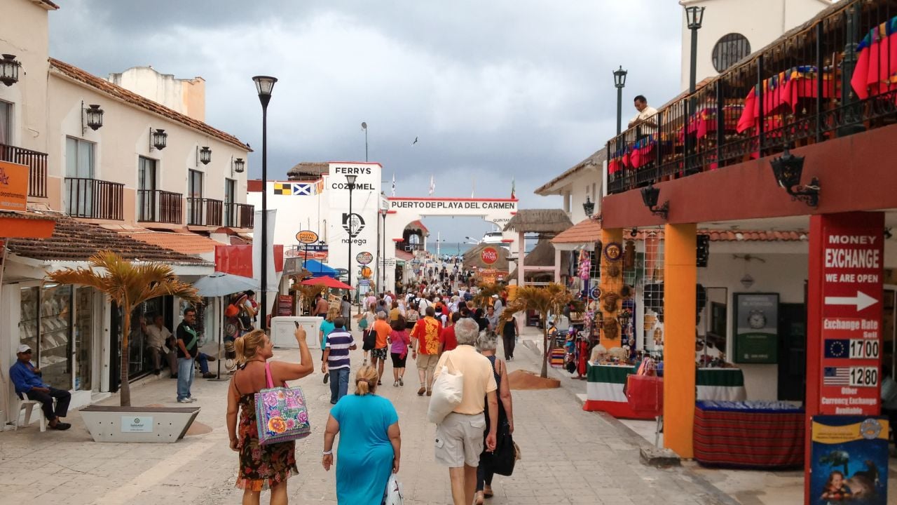 PLAYA DEL CARMEN, MEXICO - FEBRUARY 7, 2010: Tourists along city streets. Approximately 2 million tourists per year visit Playa del Carmen and its surroundings.