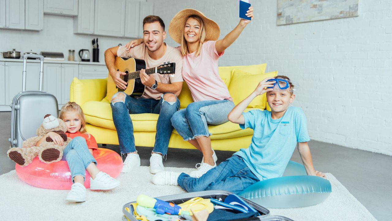 happy family holding passport, packing baggage for summer vacation and having great time, travel concept
