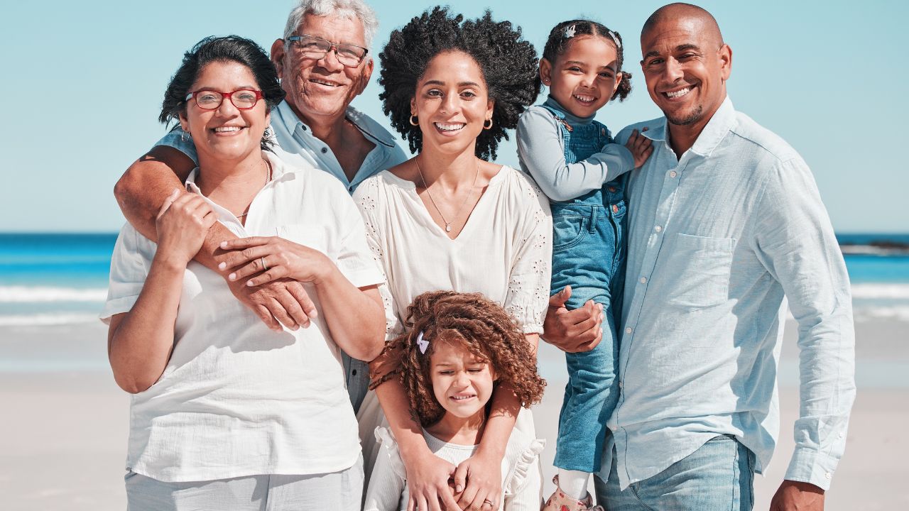 Smile, big family and portrait at beach on vacation, bonding and care at seashore. Holiday relax, summer ocean and happy father, mother and children, girl or grandparents enjoying time together.