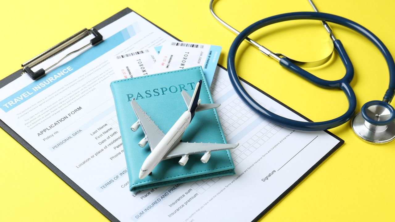 Medical tourism. Travel insurance application form, stethoscope, passport with tickets and airplane model on yellow background, closeup