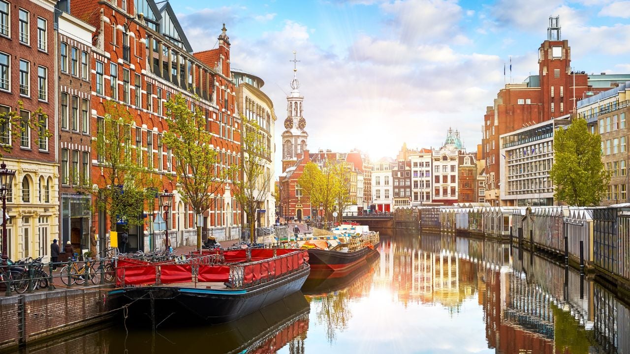Canal houses and the Amstel River in Amsterdam at sunset