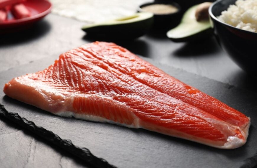 Fresh salmon for sushi on dark table, closeup