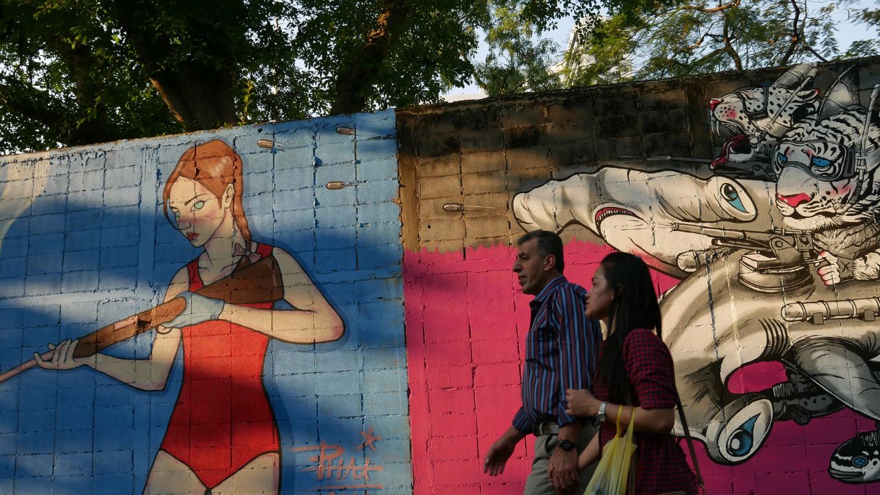 Bangkok, Thailand-February 5, 2016: View of street art on the wall in a Soi (lane) of Bangruk area of Bangkok. People walk past the art. Some come to take photos with the art.
