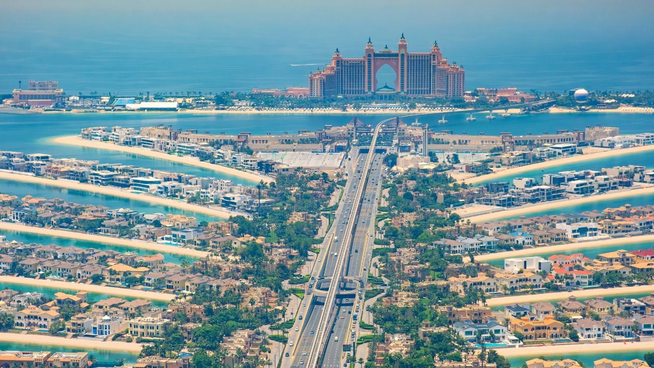 Aerial view of The Palm Jumeirah artificial island with luxury villas and Atlantis hotel in the background, Dubai city, UAE
