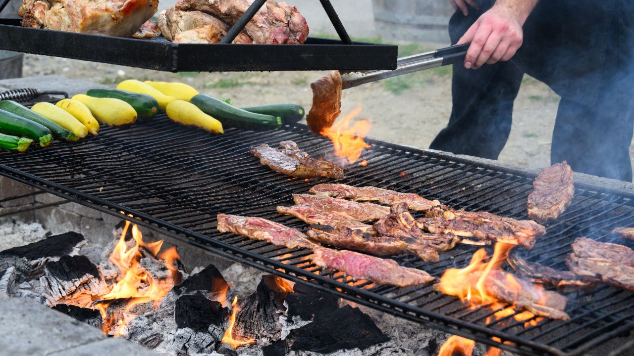 Beef grilling over open flames reflects the traditional Santa Maria Valley barbecue style