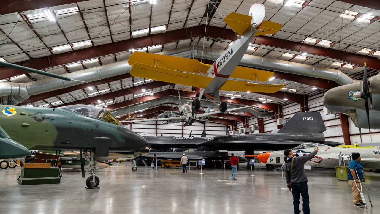 Historic aircraft on display inside a hangar highlight the region’s aviation history and museum experience
