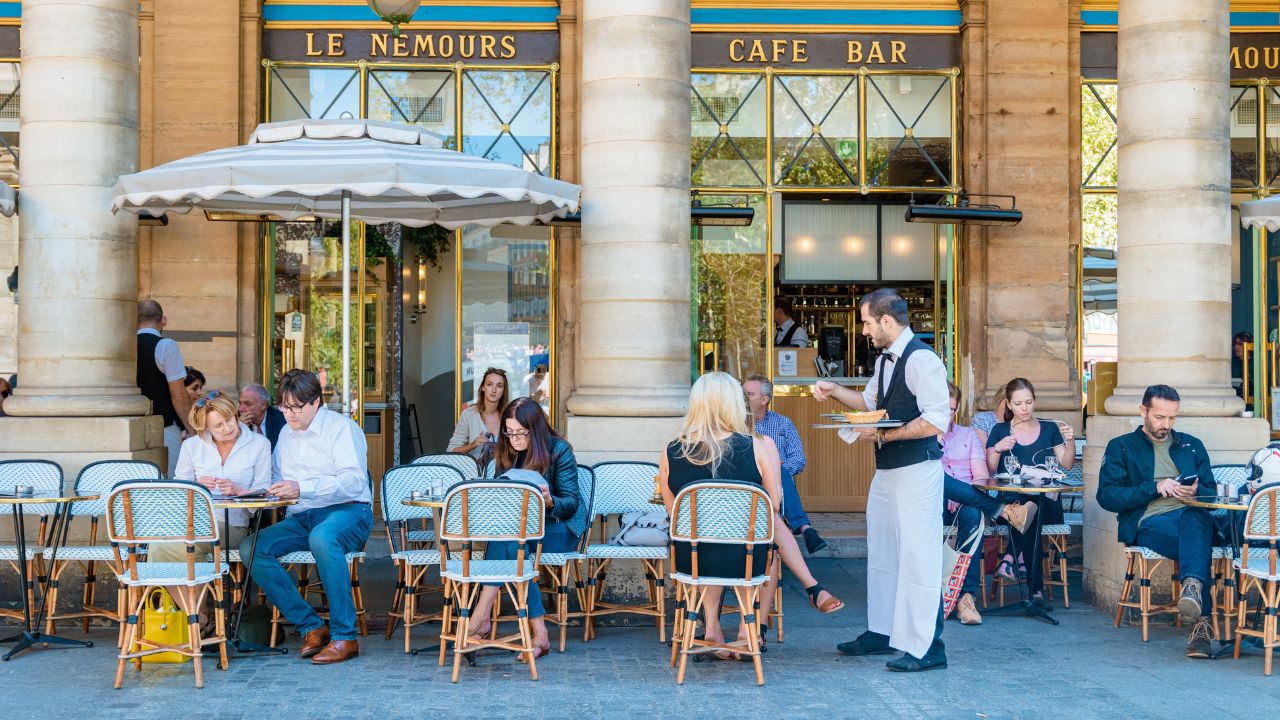 Paris France September 2021, people drinking coffee on the terrace of a cafe restaurant during the Autumn end of summer.