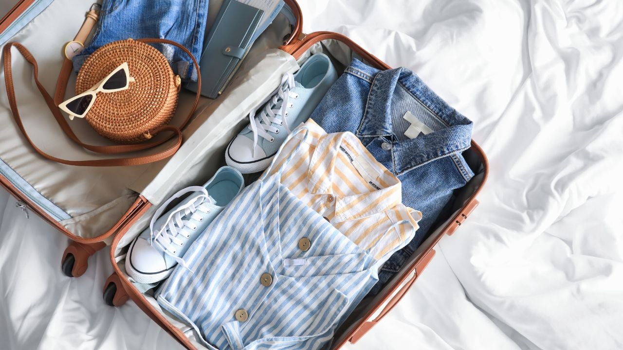 Open packed suitcase on bed