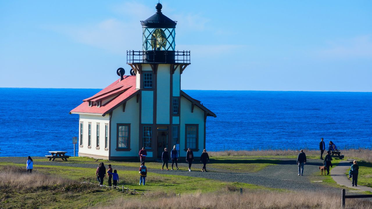 Tourists and visitors exploring lighthouse at Point Cabrillo Light Station - California, USA - November 24, 2023