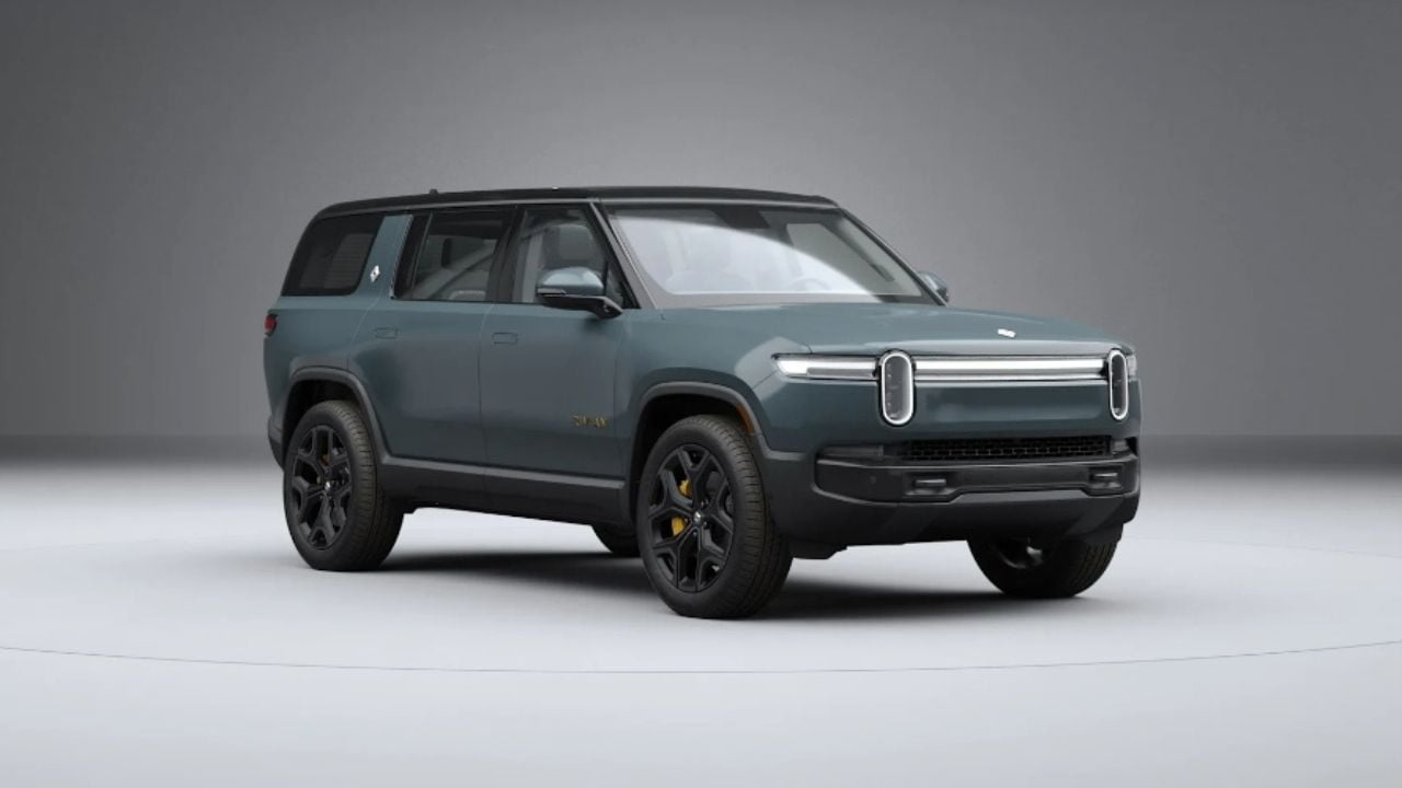 Rivian R1S electric SUV (2022–2024 model) parked outdoors showing its front design and LED headlights.