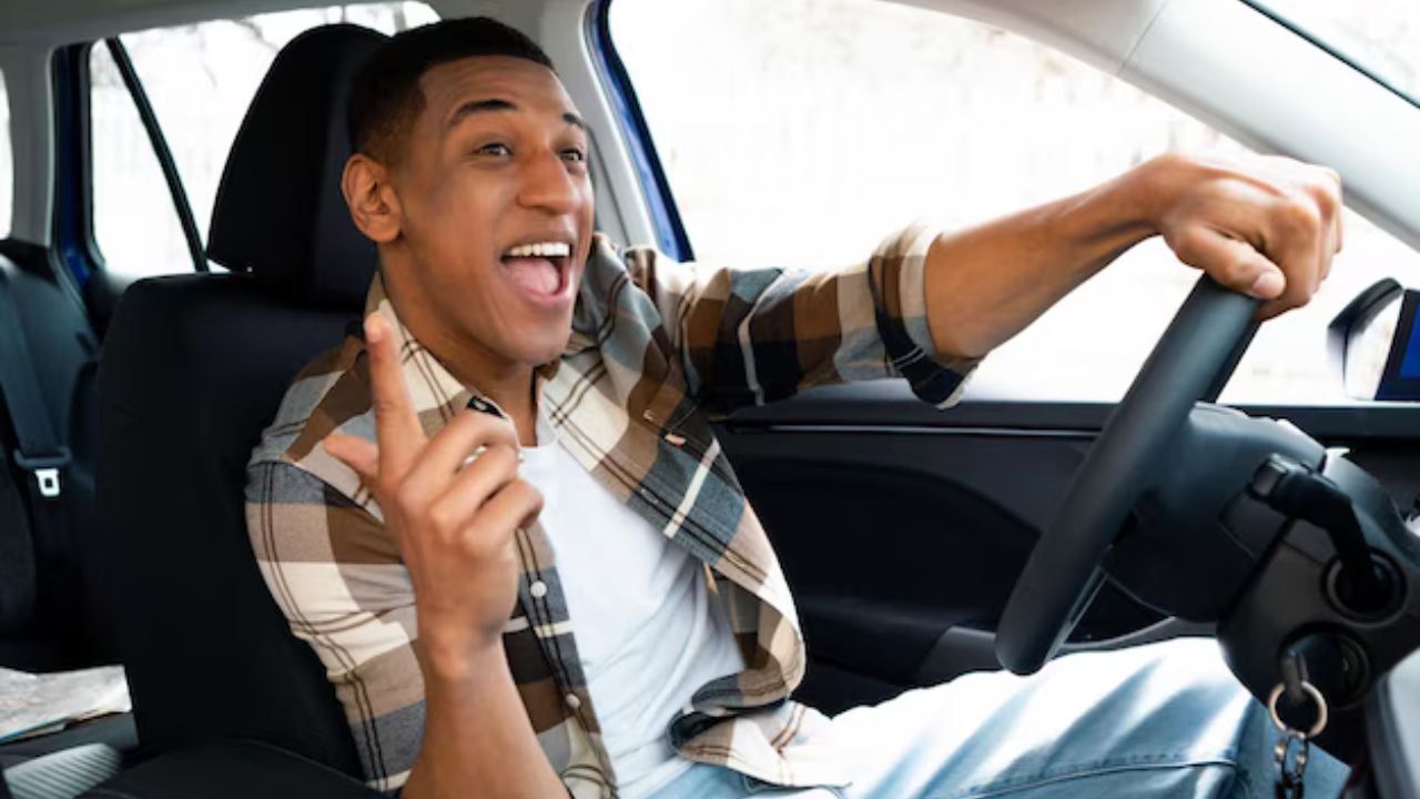 Excited man singing along road trip playlist.