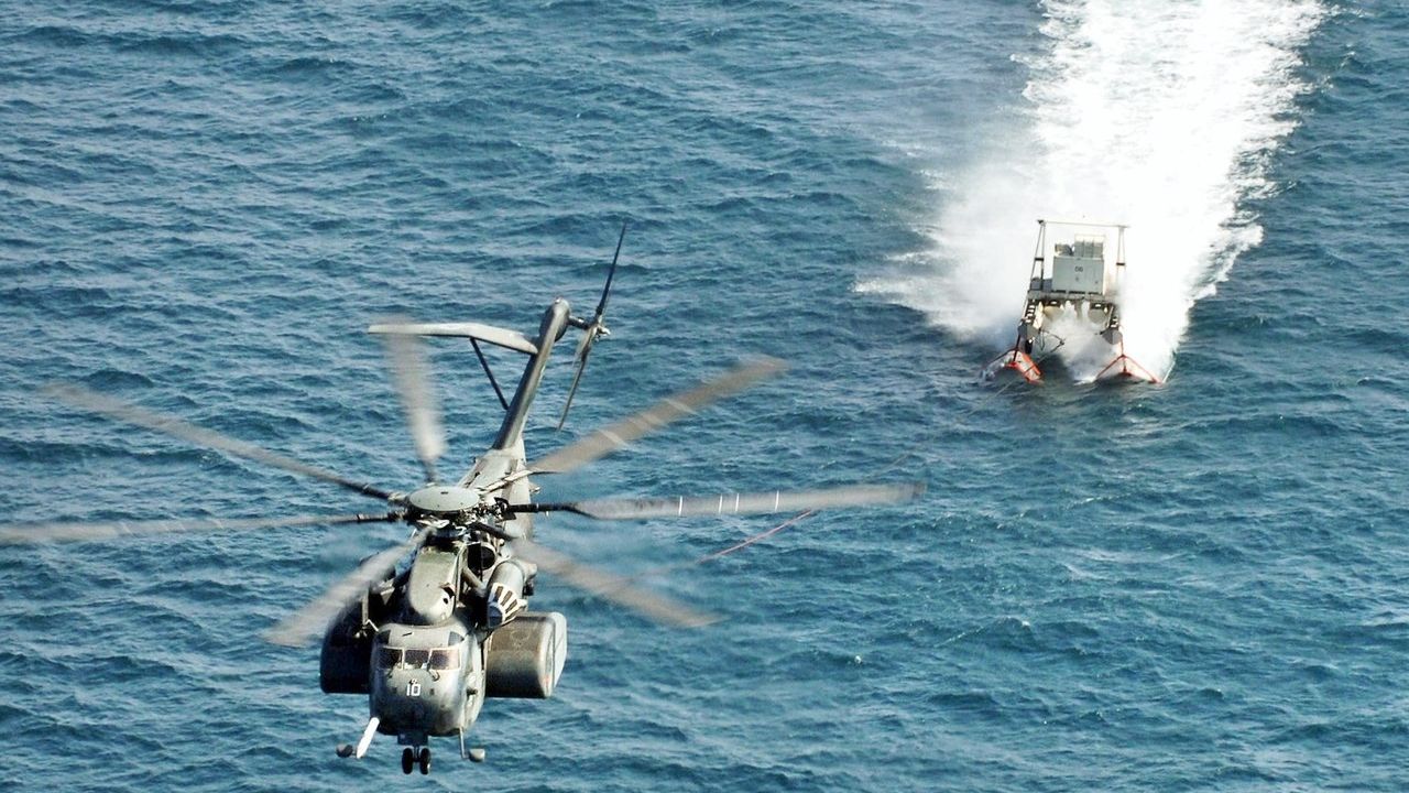 An MH-53E Sea Dragon, from Helicopter Mine Countermeasure Squadron (HM) 15, performs mine countermeasure training using the MK-105 sled.
