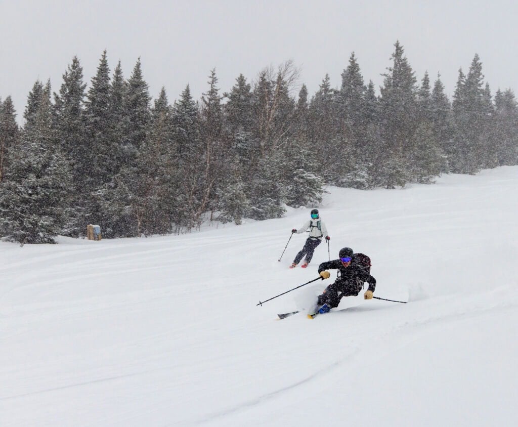 a skier heads down the slopes