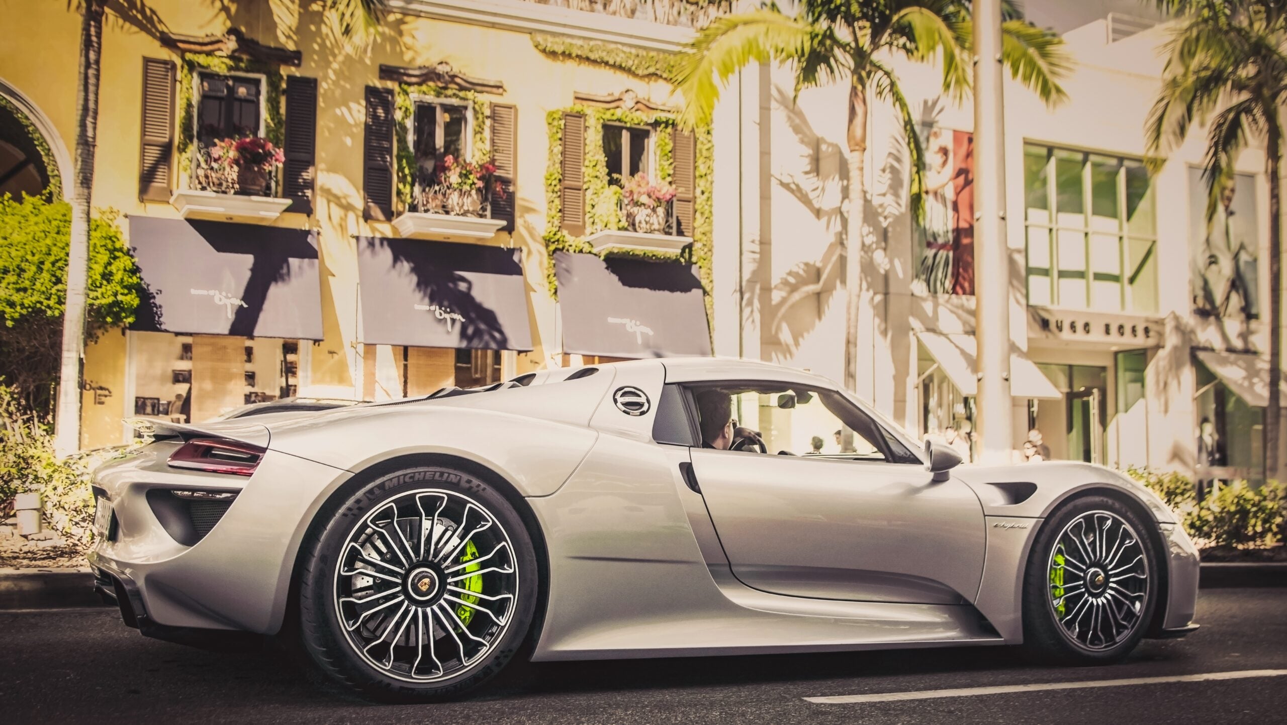 Beverly Hills, Year 2018: Porsche 918 Spyder driving on Rodeo Drive. Hybrid hypercar. Traffic.