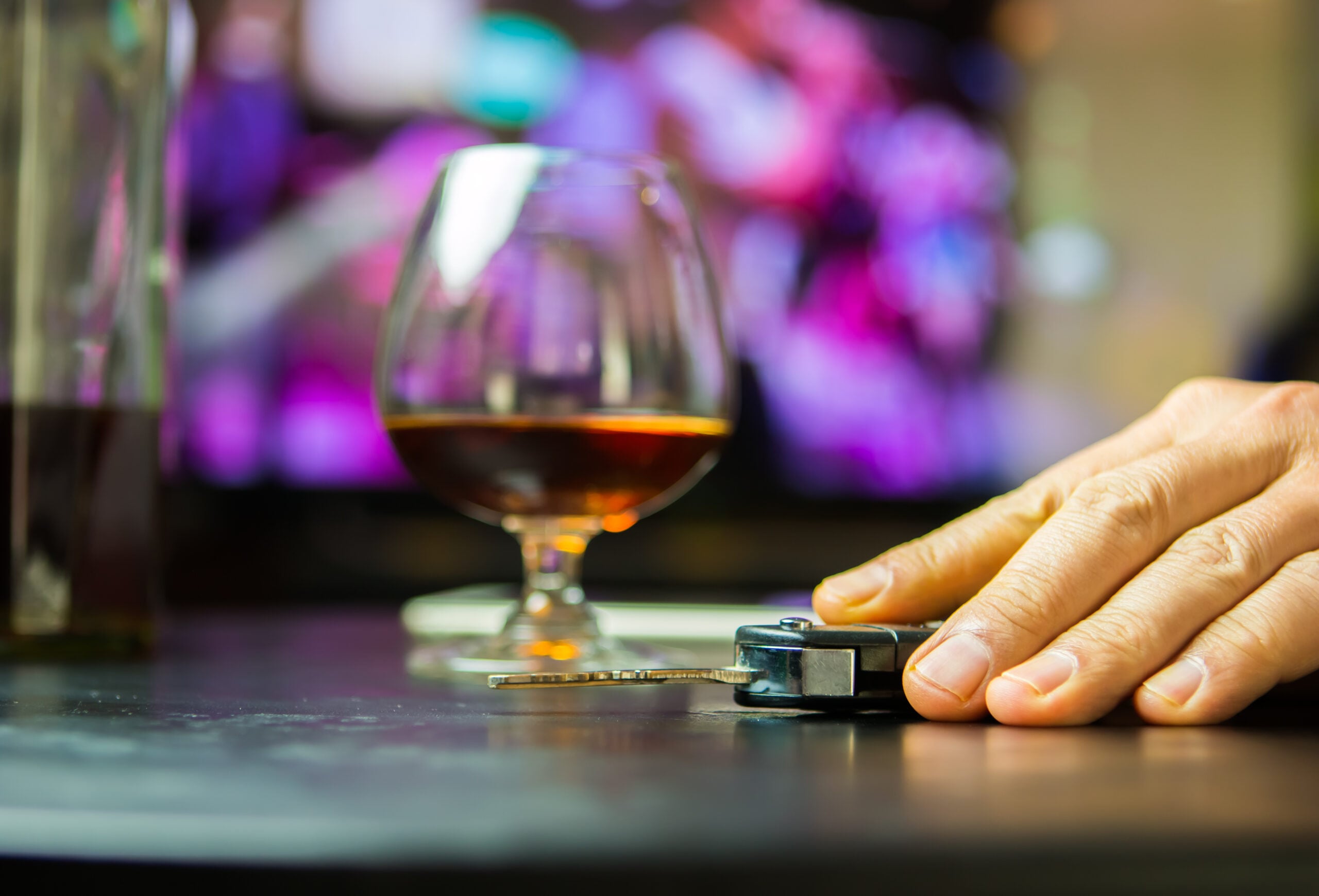 man with car keys and wine