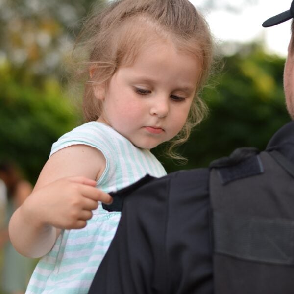 cute kid held by police